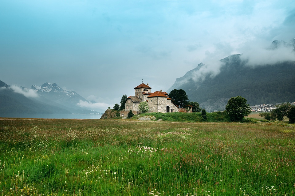 Castle on the end of a grassy field in Saint Moritz, Switzerland photo