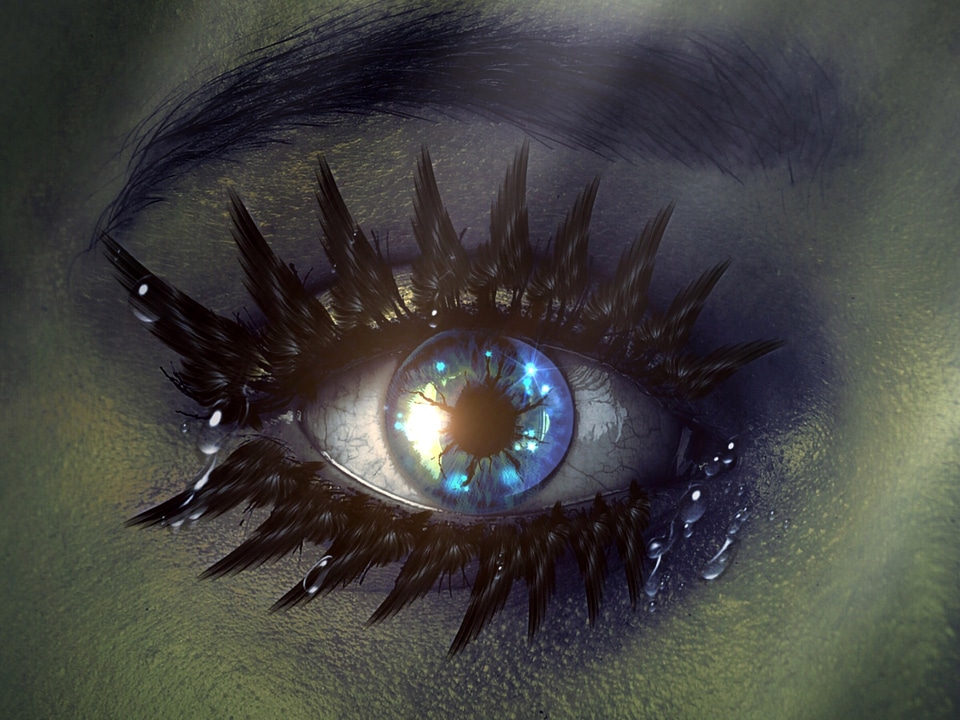 Teardrops from a crying blue eye