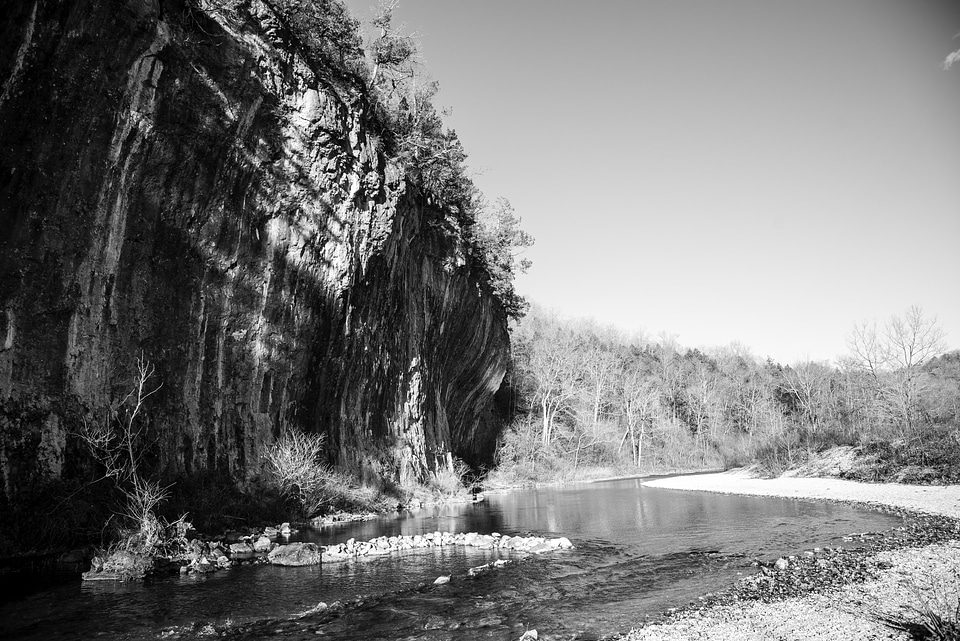 Monochrome photo of current river and cliff at Echo Bluff State Park, Missouri