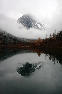 Mountain and Reflection with clouds and Mist in the water in Sichuan, China photo
