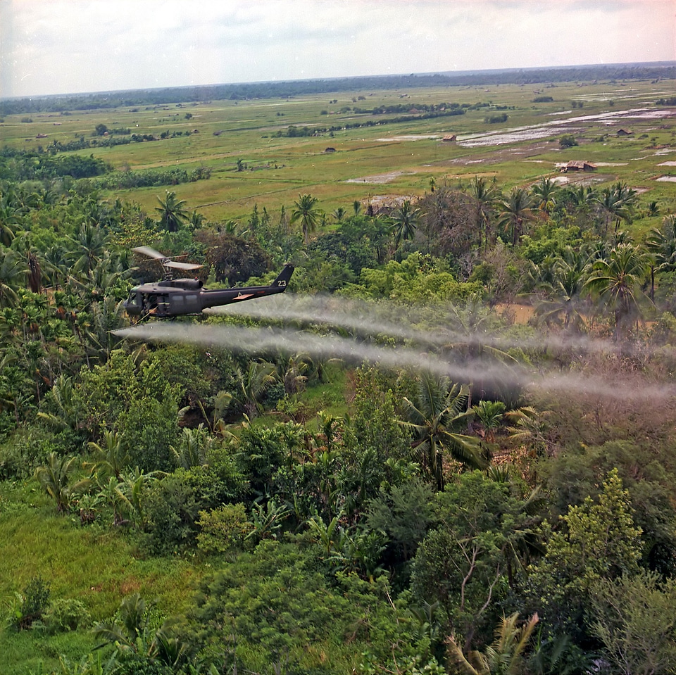 Helicopter spraying chemical defoliants in Vietnam