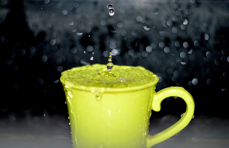 Raindrops falling in a cup
