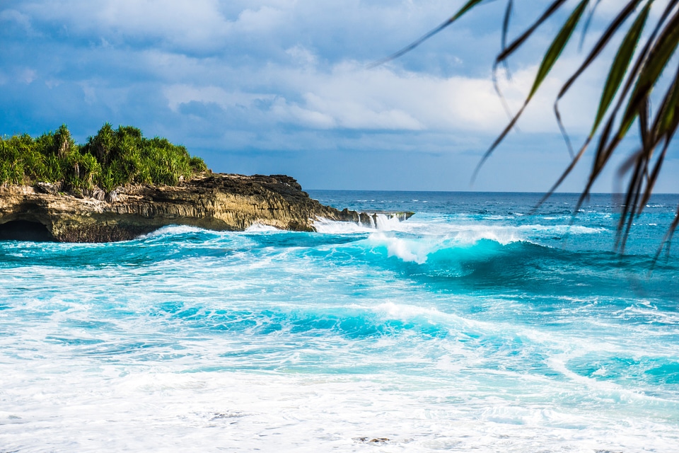 Waves on the ocean crashing on shore in Indonesia
