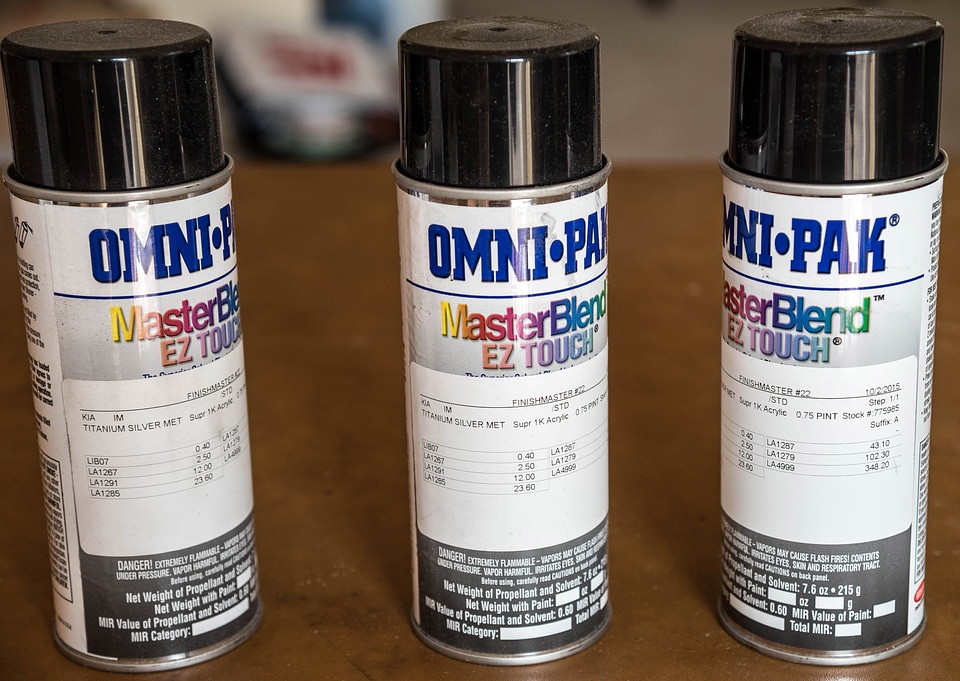 Three spray paint cans