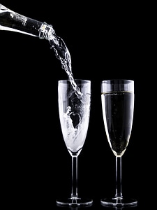 Pouring two cups of sparkling wine photo