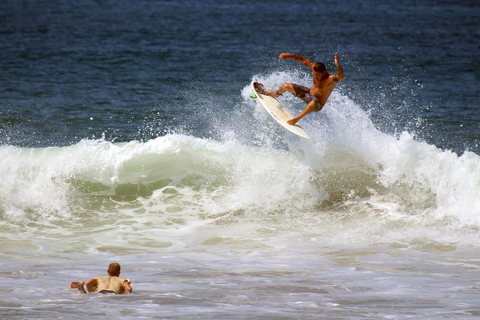 Two surfers riding waves in the ocean