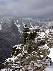 Man standing on the cliff in the white mountains landscape in New Hampshire photo