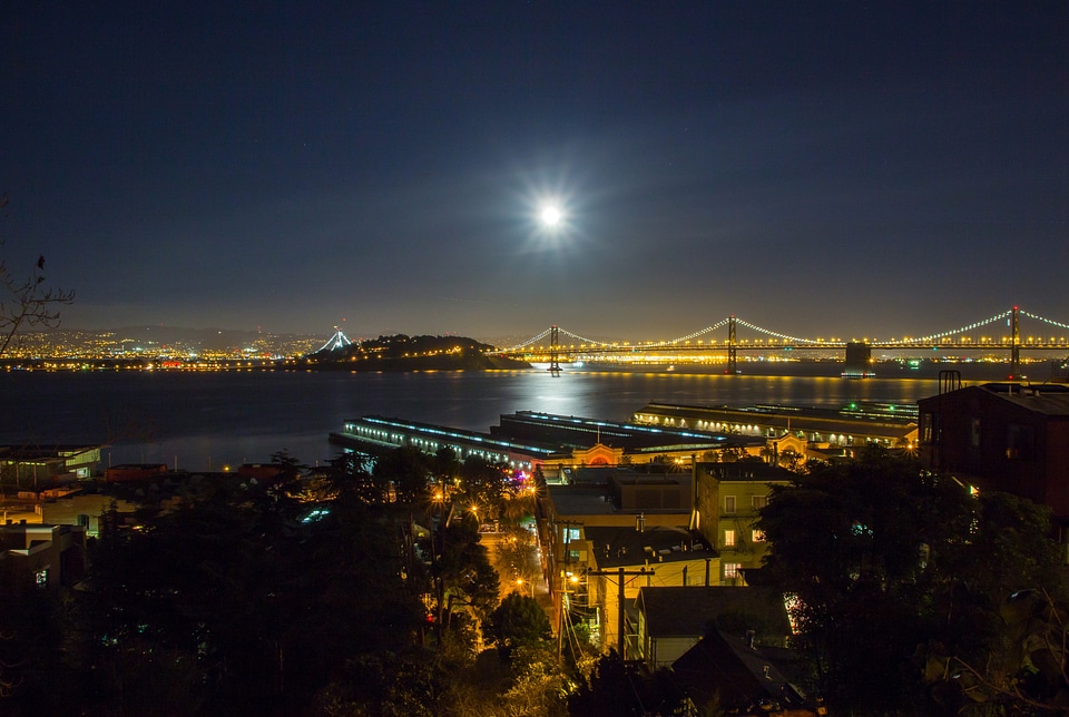 Night Time Cityscape view of Oakland-San Francisco Bay Bridge with sky and moon in California