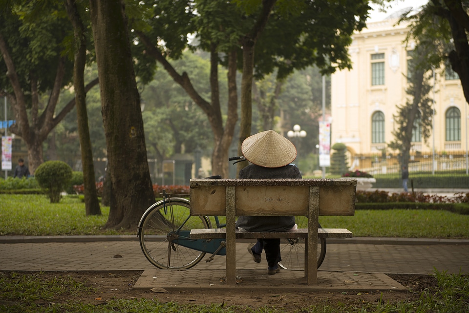 Person sitting on a bench on Hanoi, Vietnam
