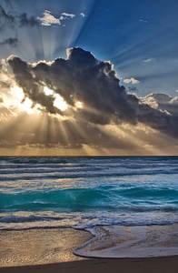 Sun Behind the clouds over the Sea in Cancun, Mexico