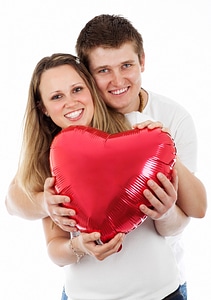 Couple holding heart balloon on Valentine's day photo