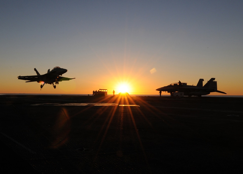 Fighter jets landing at sunset