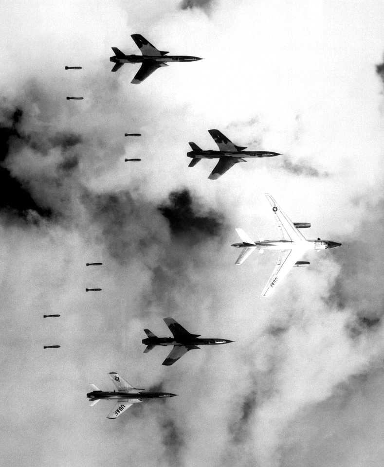  B-66 Destroyer and four F-105 Thunderchiefs dropping bombs in the Vietnam War