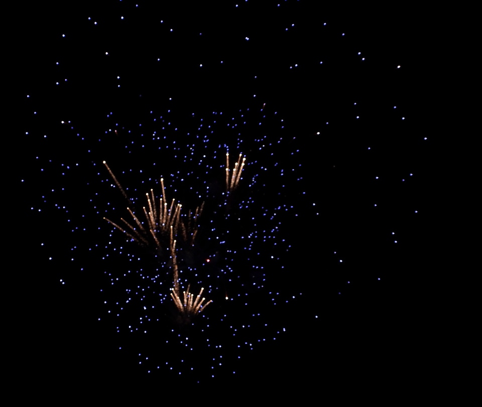 Blue and orange explosion in night sky