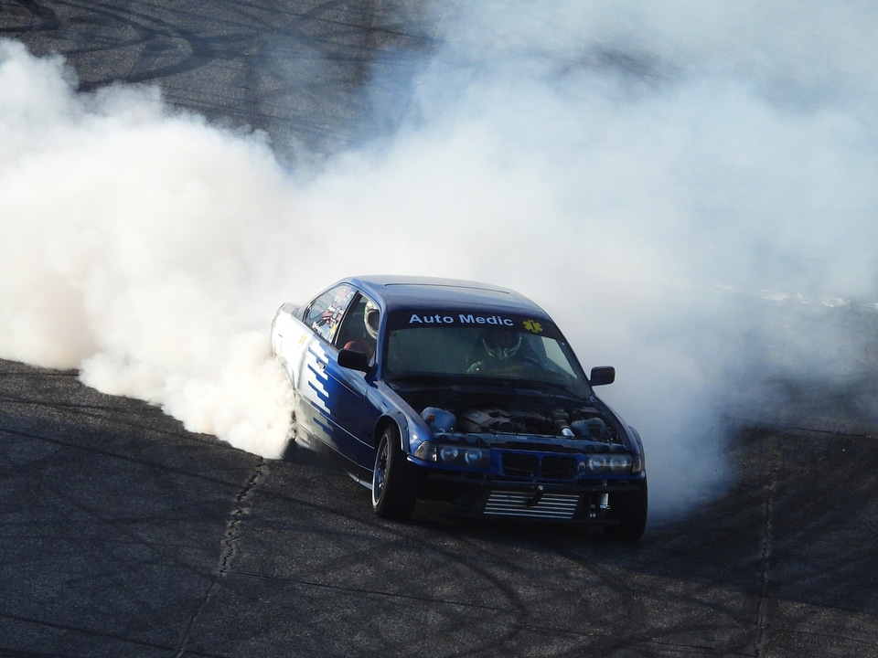 Massive Rubber burning by cars around racetrack