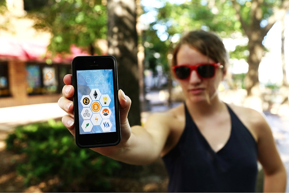 Woman with crypto symbols on phone