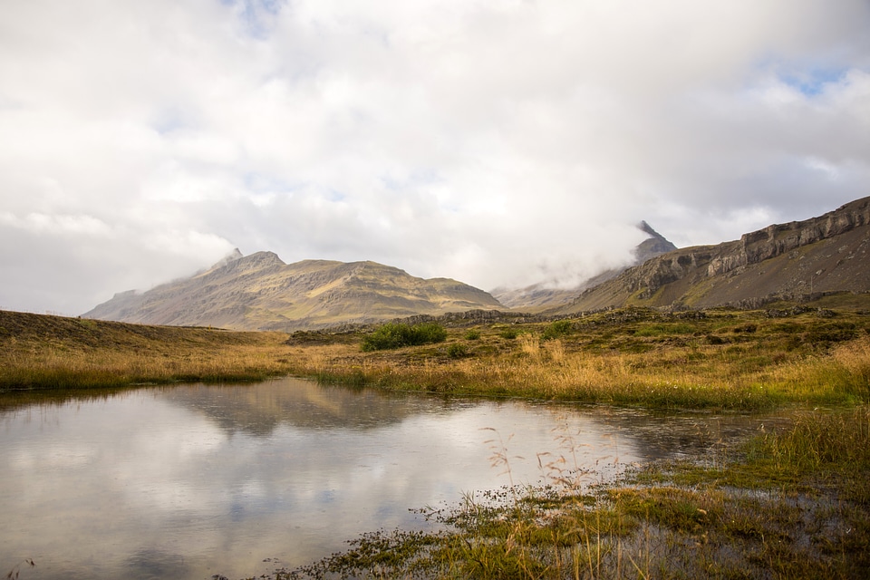 Pond landscape with clouds over the water