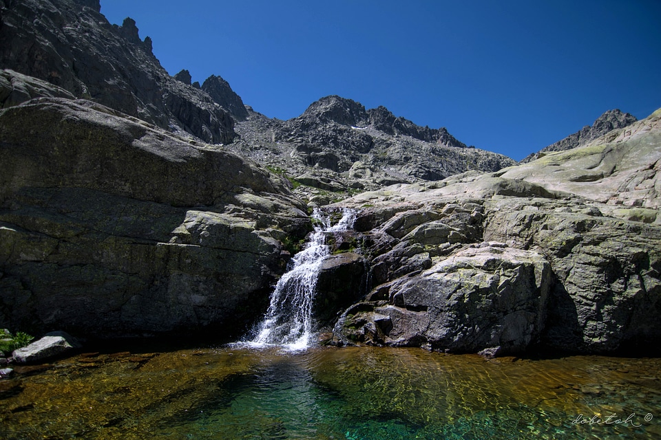 Small flowing waterfall coming down form rocks