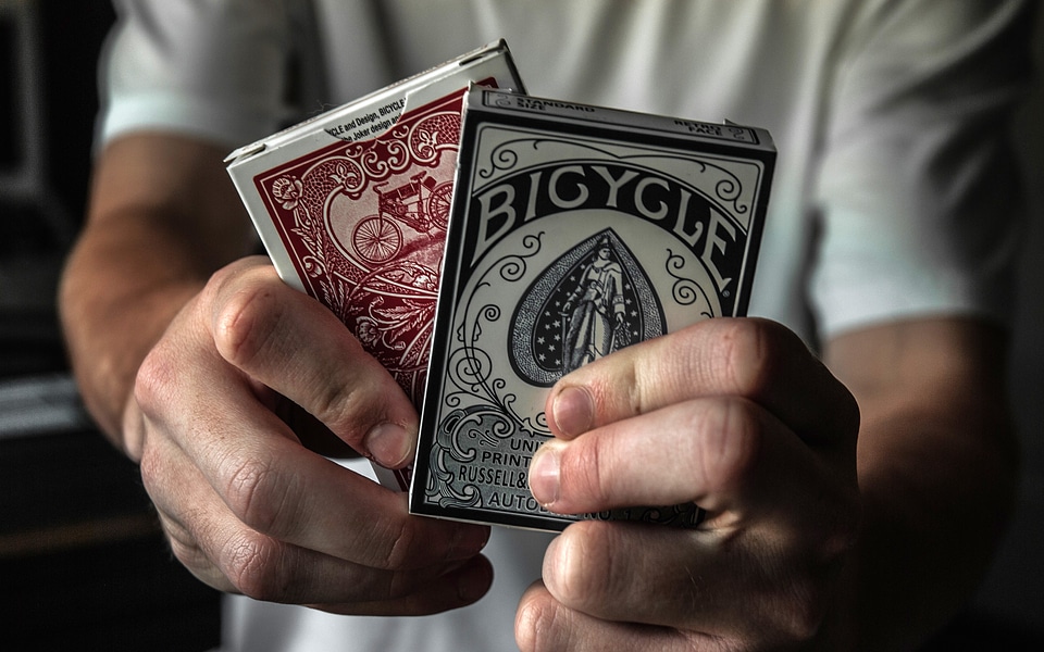 Holding two packs of cards