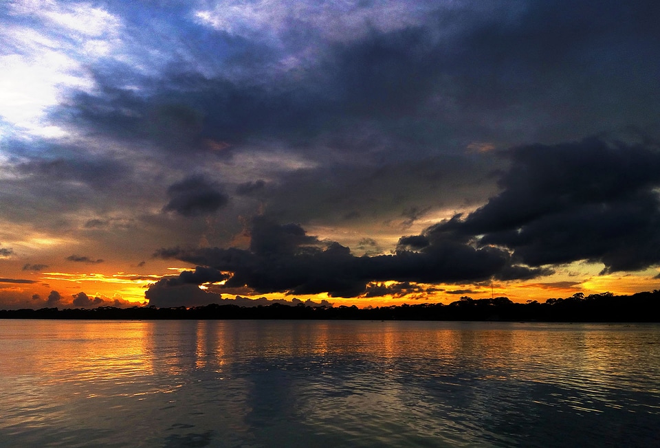 Sunset over the cloudy river photo