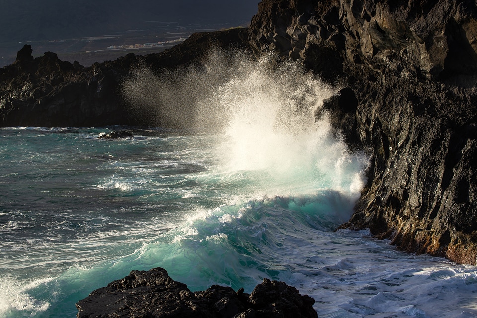 Ocean waves crashing on rocky shores photo