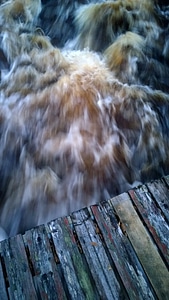 Cascading water from the top of a bridge photo