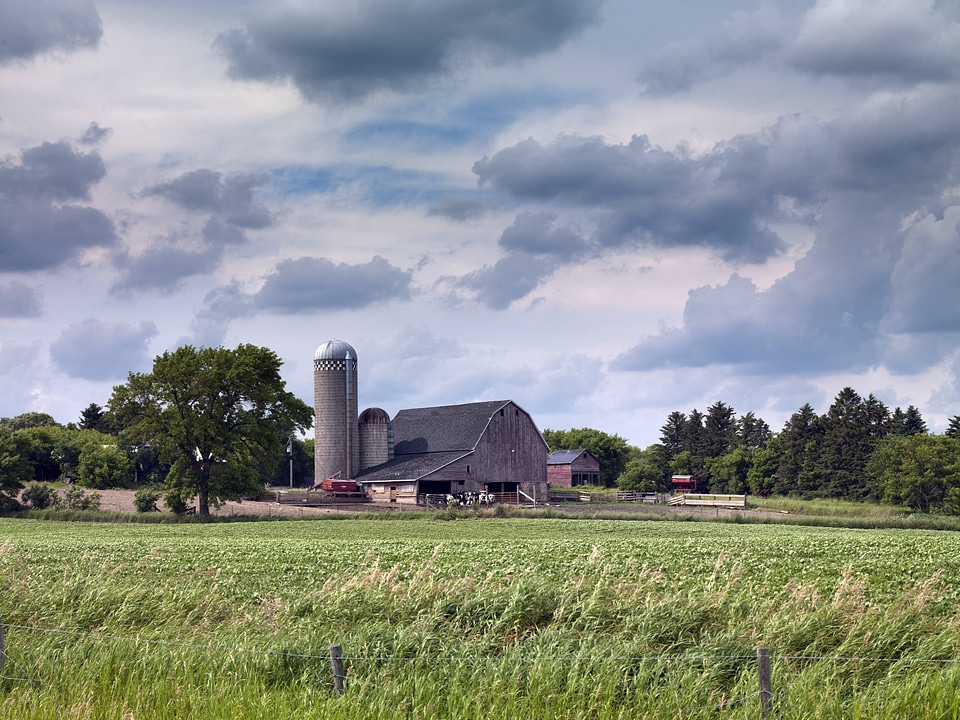 Farmhouse and farm under clouds in North Dakota