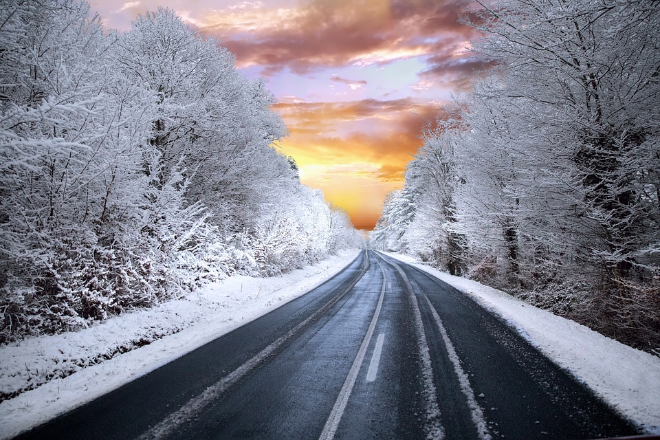 Snowy winter sunset landscape into the sunset