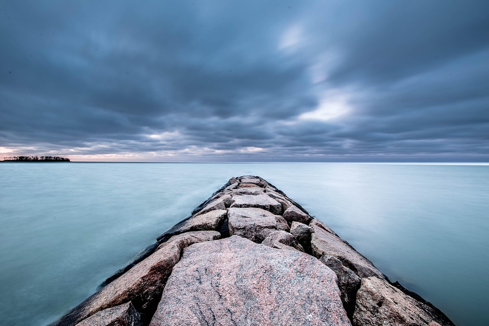 Storm clouds over the rocky walkway to the lake
