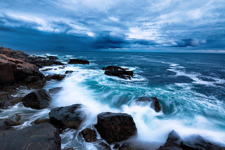 Waves of the ocean crashing on shore with skies in Acadia National Park photo