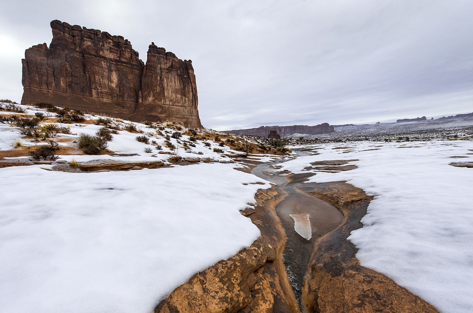 Slushy river landscape in the winter with snow in Arches National Park