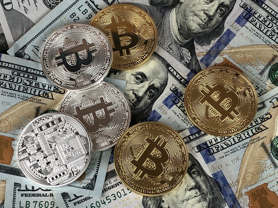 Hundred Dollar Bills and Bitcoin Coins