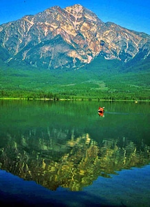 Canoeing in a emerald green lake in the Canadian Rockies