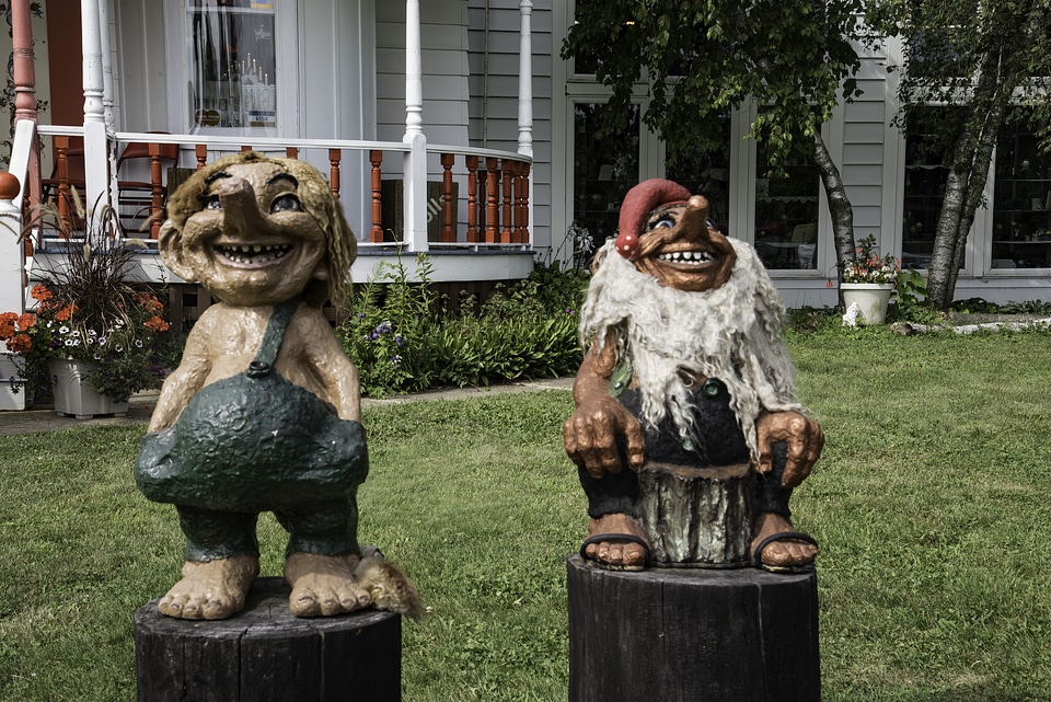 Two troll statues in front of a house in Mount Horeb