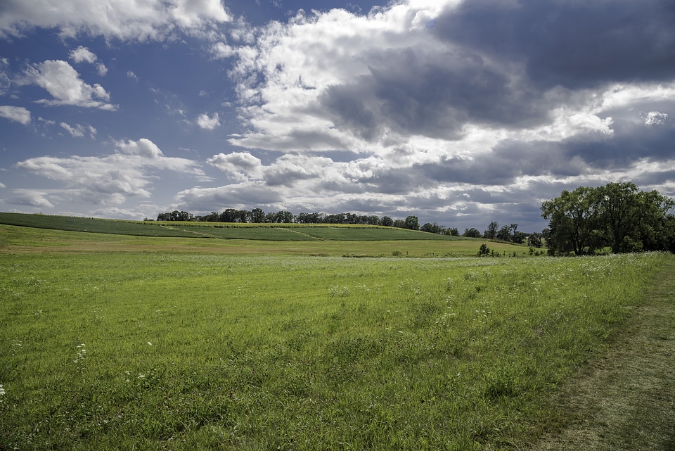 Farm and Fields under the sky and clouds