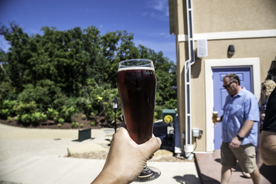 Hand holding a pint of Cherry Berry at New Glarus Brewery