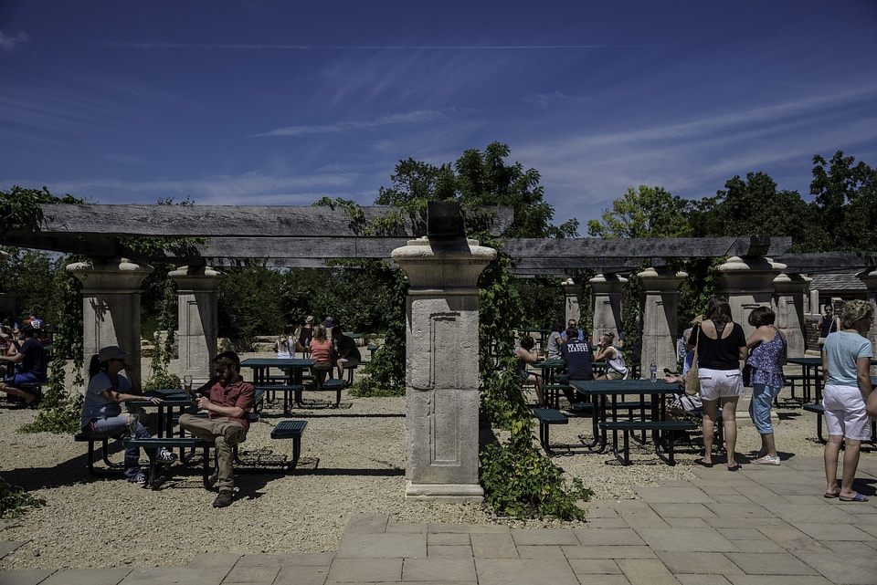 People sitting at old-fashion outdoors tables at New Glarus Brewery