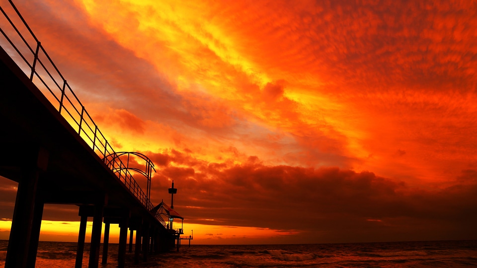 Red Skies over the sea and bridge photo