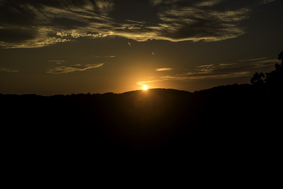 Sunset beyond hills at Great River Bluffs State Park