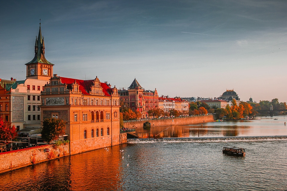 Sunset view of the river and shoreline buildings in Prague, Czech Republic