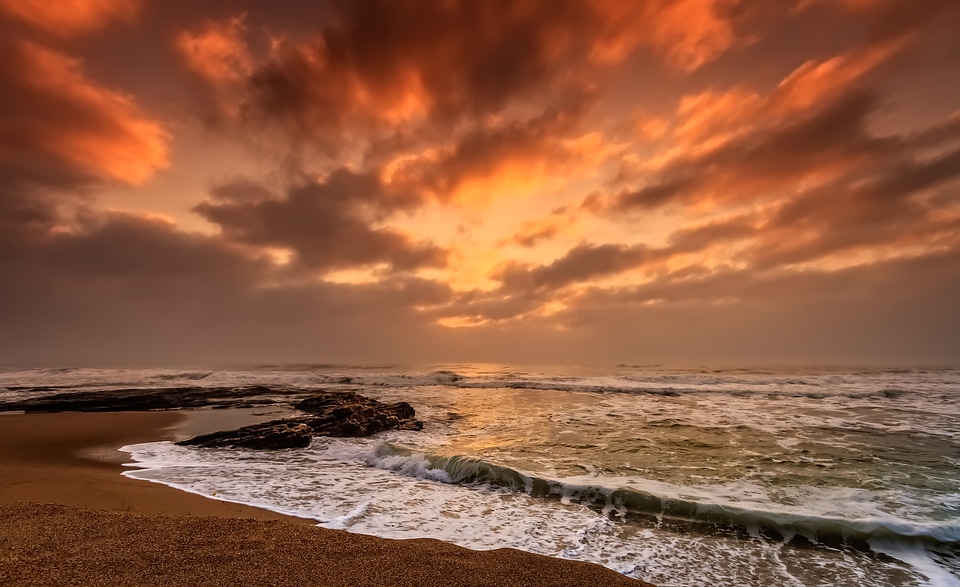 Seashore at dusk with waves and clouds in Nkwazi, South Africa