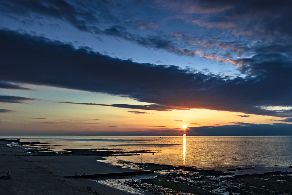Sunset and dusk over the ocean with clouds