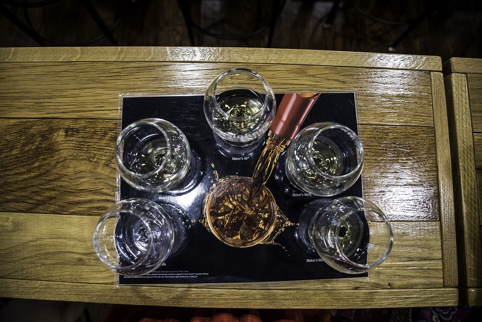 Pouring Whiskey into glasses at Maker's Mark