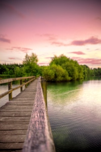 Walkway across the water into the pink skies photo
