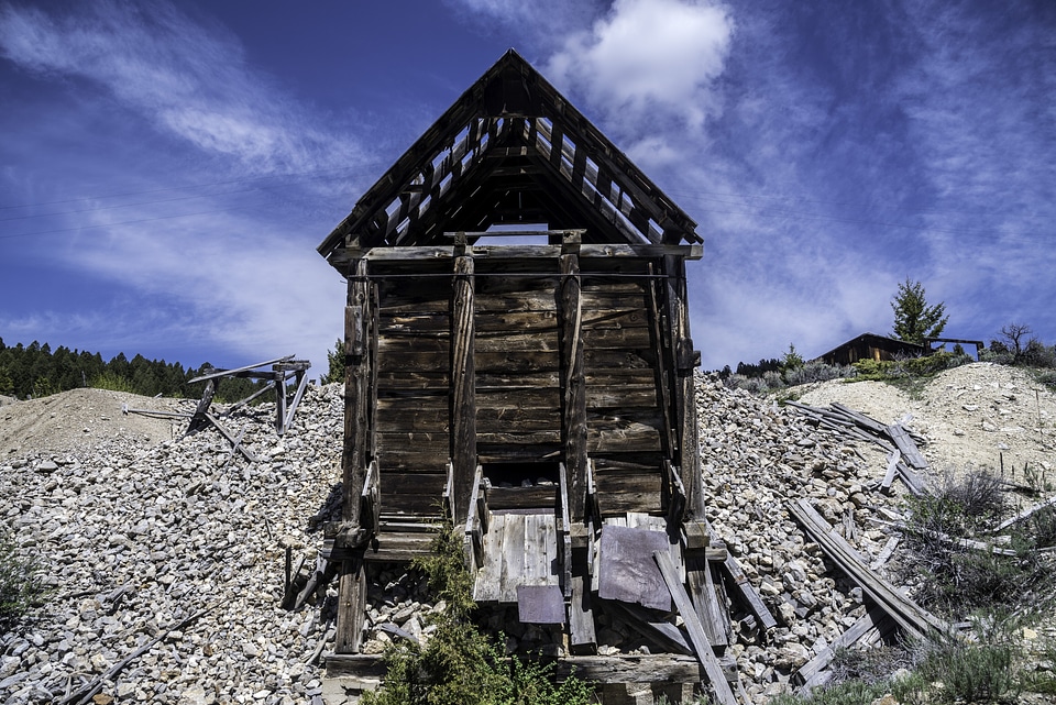 Old Rustic Cabin under blue sky and clouds in Elkhorn, Montana