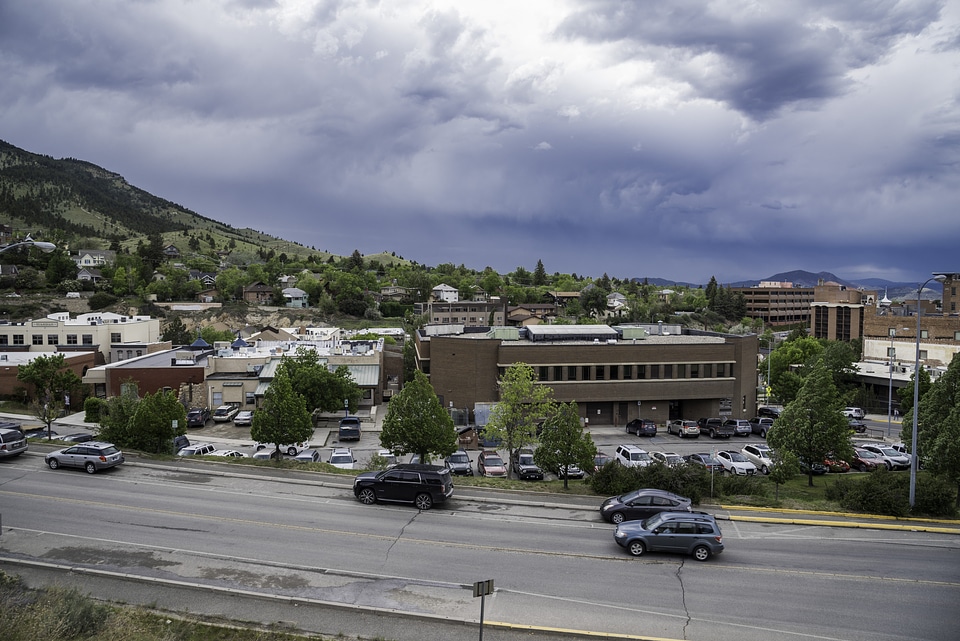 Cars and buildings under cloudy sky in Helena, Montana
