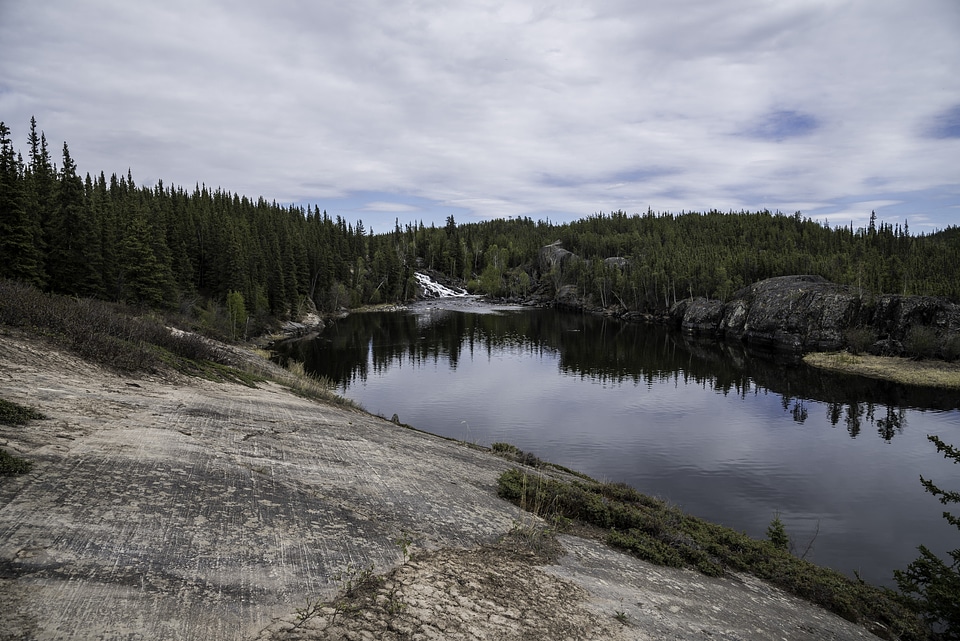 Landscape of the Cameron River with the waterfall in the distance on the Ingraham Trail