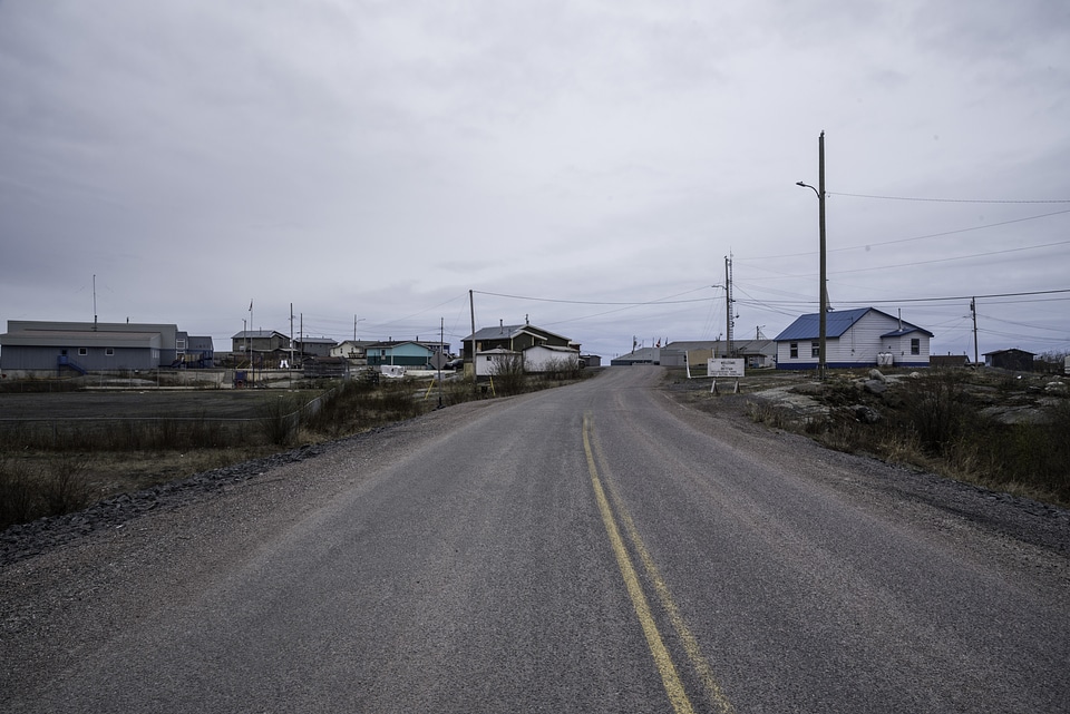 Road into Dettah under cloudy skies on the Ingraham Trail