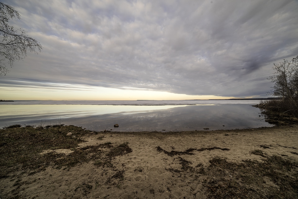 Beach and Great Slave lake under dramatic clouds