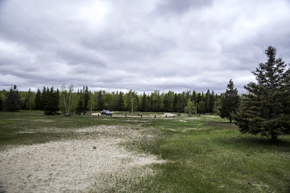 Parking lot landscape under cloudy skies, Zippel Bay State Park